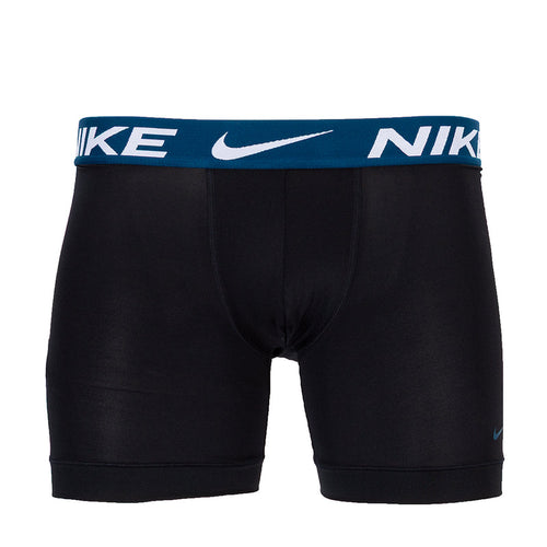 Black boxer briefs with blue waistband and NIKE logo print, mid-thigh length