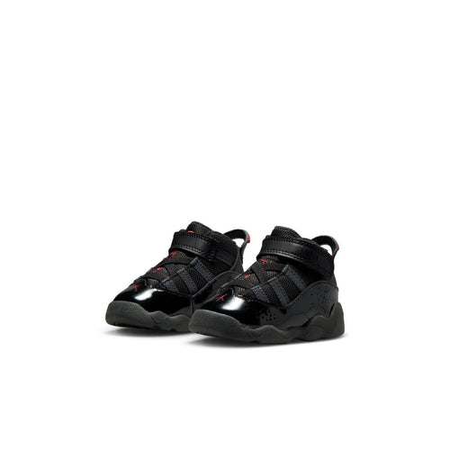 Pair of black toddler sneakers with red accents, side straps, and grippy gray outsole.