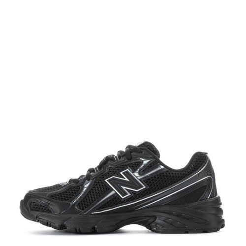 Youth black lace-up sneakers with bold silver N logo and textured midsole