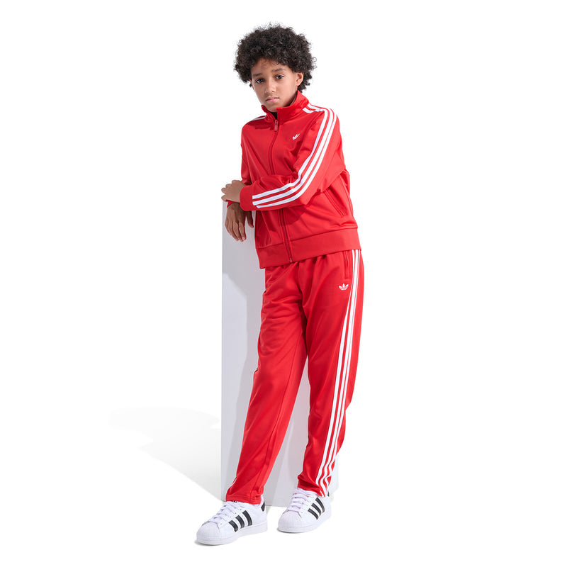 Youth red track pants with white side stripes and zip-style front