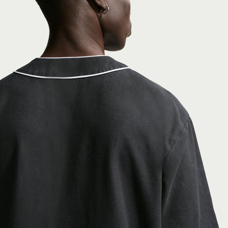 Men's black baseball top back view with white collar trim